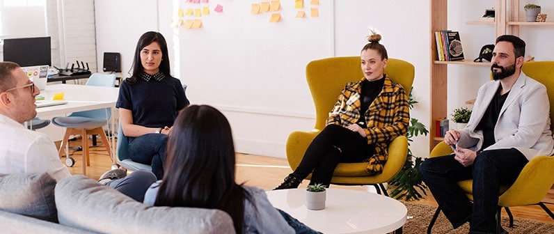 several people sitting on a meeting