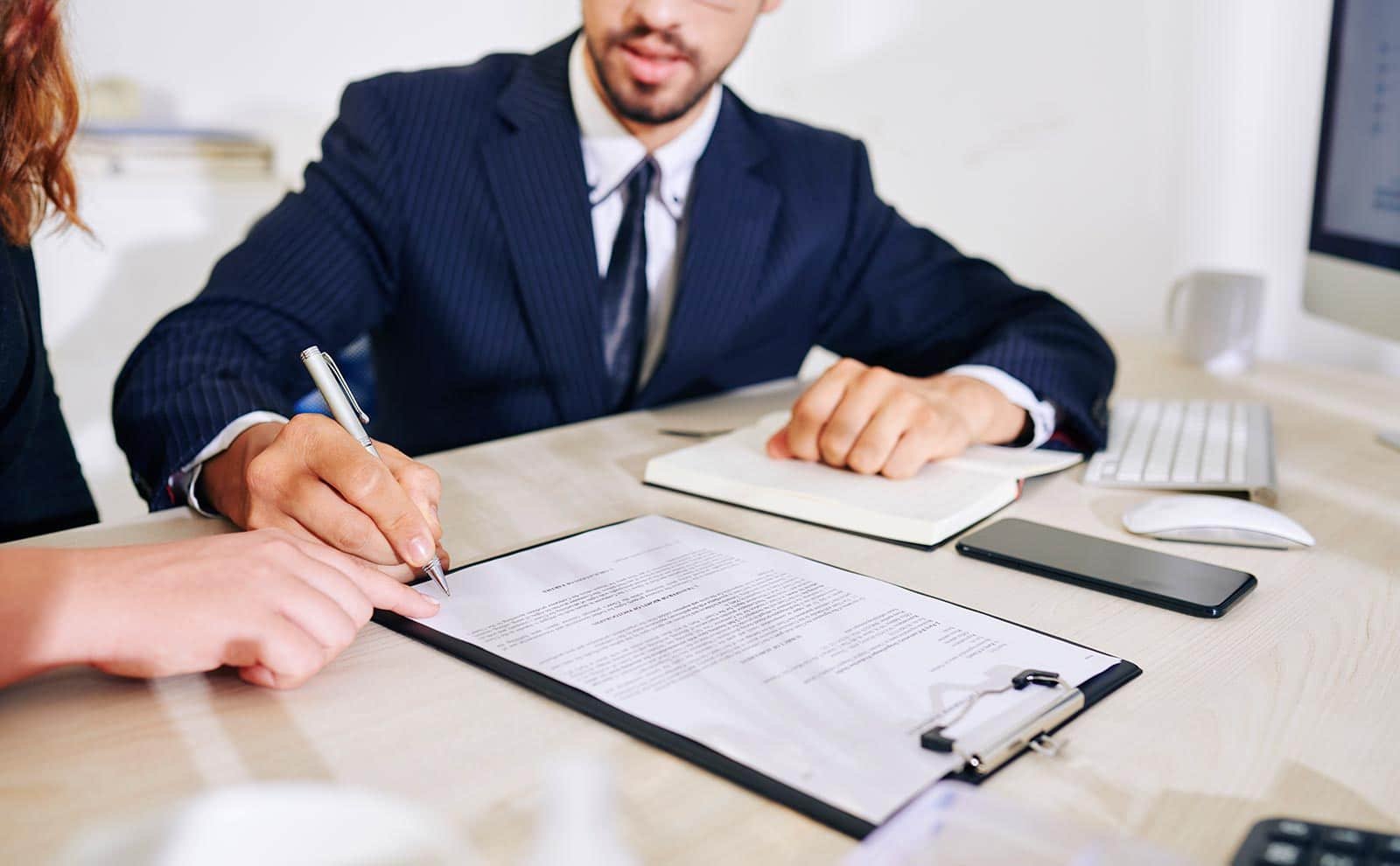 a man and a woman signing a contract