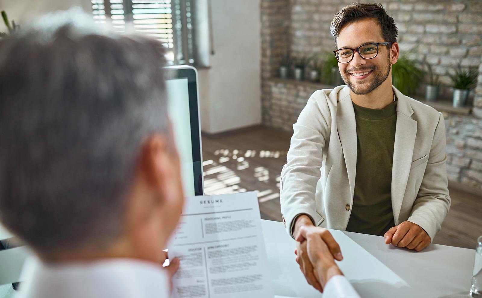 employer and employee shaking hands