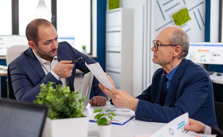 two serious men negotiating in an interview