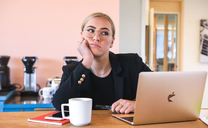 woman worried with a laptop and a coffee