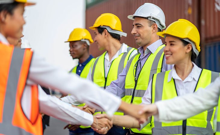 Trends In The Staffing Industry: Expert Insights &Amp; Strategy Independent Recruiter LLC | Staffing Agency workers with helmets and security vests shaking hands