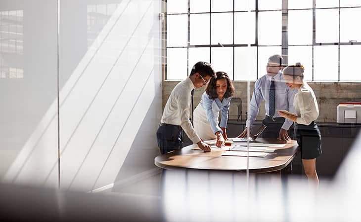 group of people working together around a table