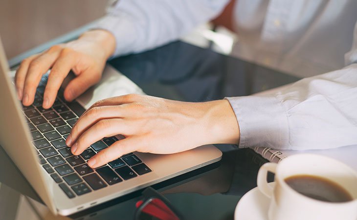 How To Find A Job: Expert Guide For Mastering Job Hunting Independent Recruiter LLC | Staffing Agency person-hands-writing-laptop