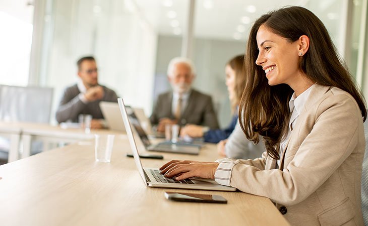 Program Manager Job Description: Essential Skills Guide Independent Recruiter LLC | Staffing Agency smiling-woman-working-laptop-office