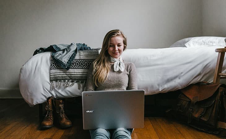 happy-woman-laptop-floor
