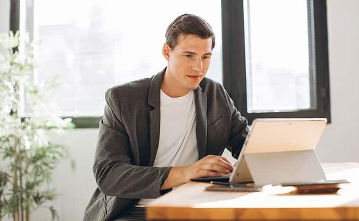 man-looking-tablet-table