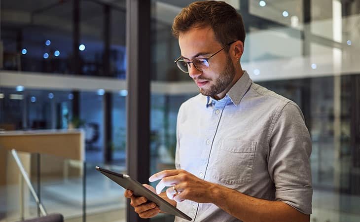 man-standing-using-tablet
