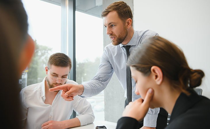 man-talking-workers-discussing-office