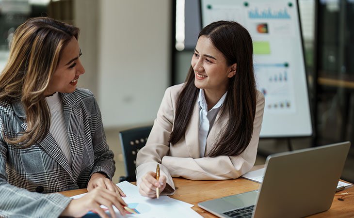 smiling-women-talking-work
