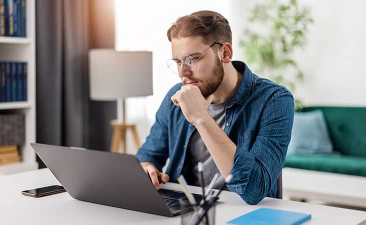 thoughtful-man-looking-laptop
