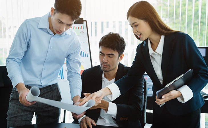 three-people-talking-work-office