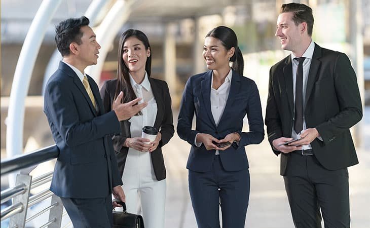 happy-executives-talking-outdoors