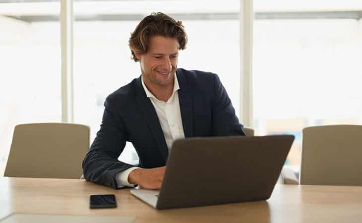 smiling-man-using-computer