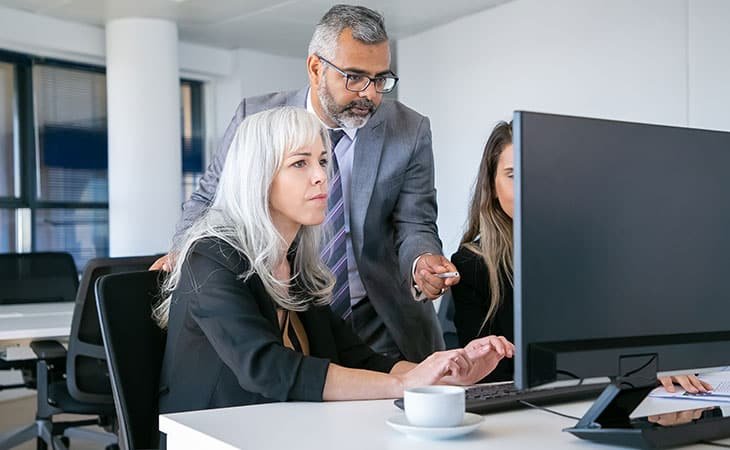 people-working-computer-man-pointing-screen