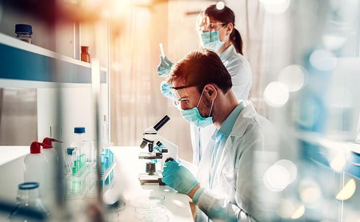 chemists-investigating-using-microscope