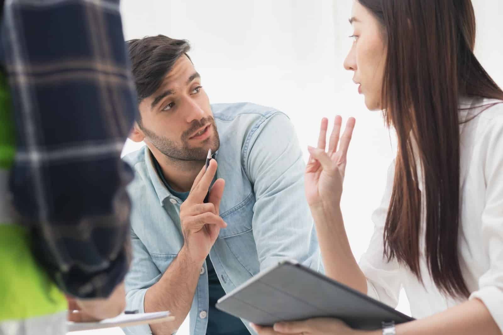 coworkers-discussing-numbers-hands