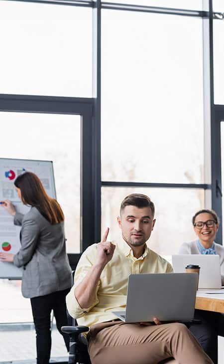 man-using-laptop-pointing-up