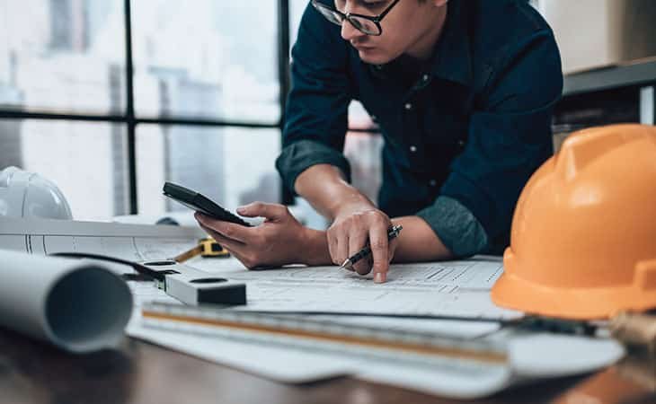 man-working-papers-phone