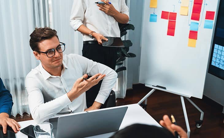men-meeting-post-its-board