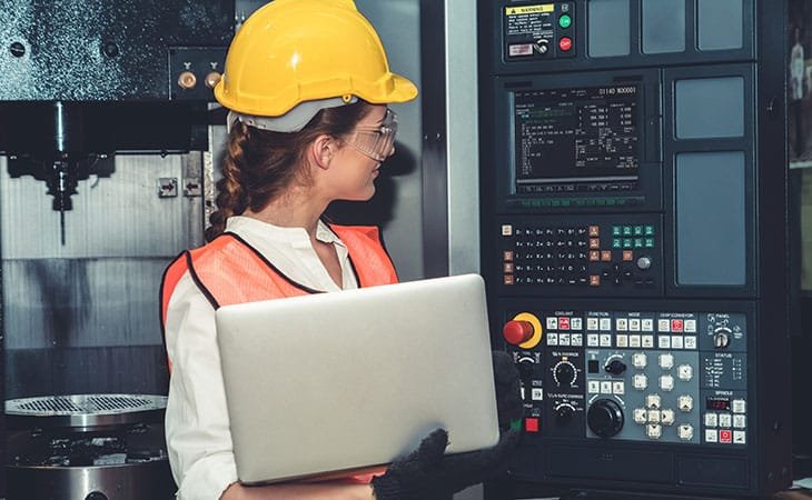 woman-holding-laptop-helmet-machine