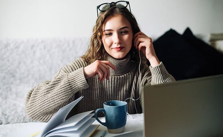 woman-home-using-laptop-headphones