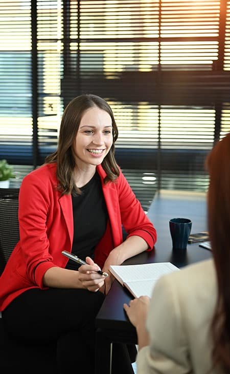 women-talking-inside-office