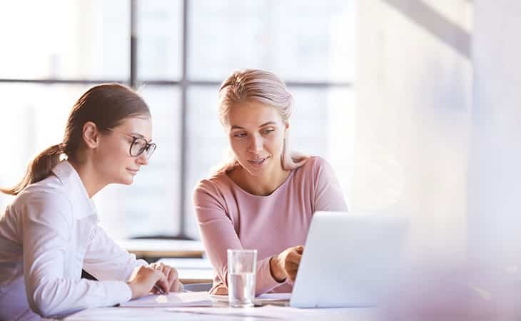 women-talking-table-computer