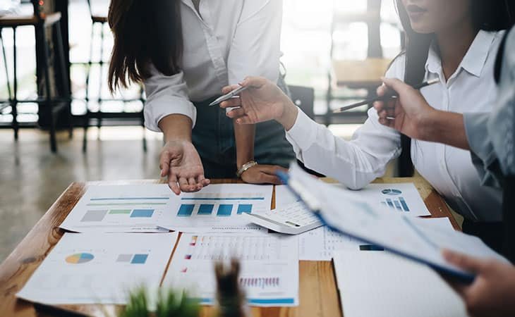business people discussing data graphs
