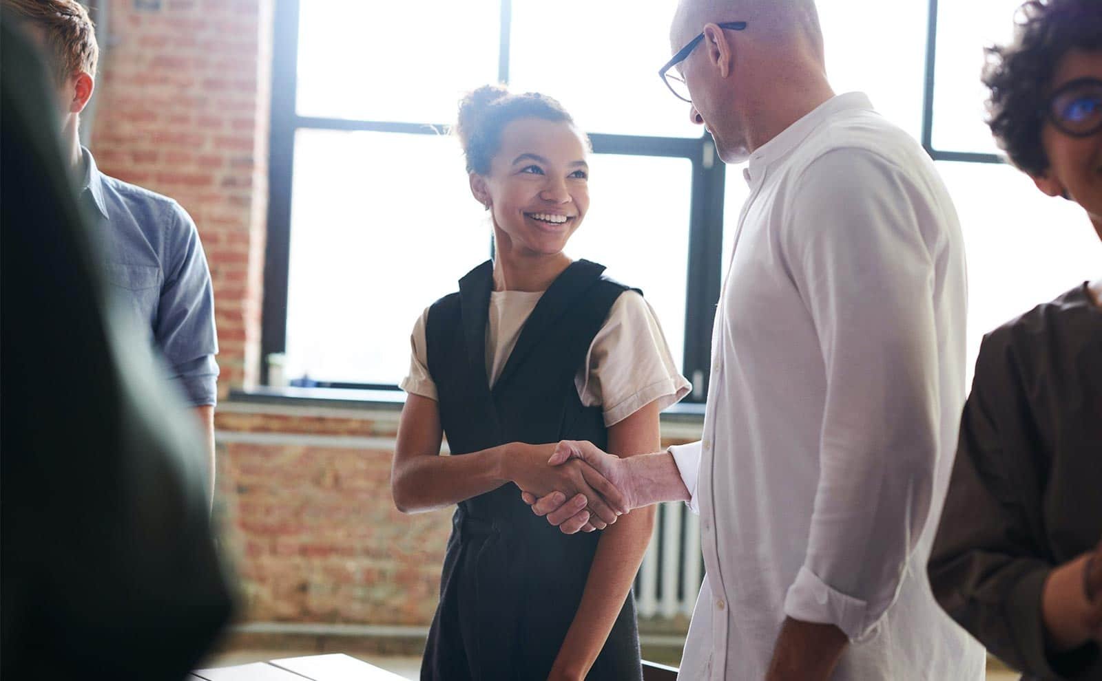 happy woman shaking hands with a man