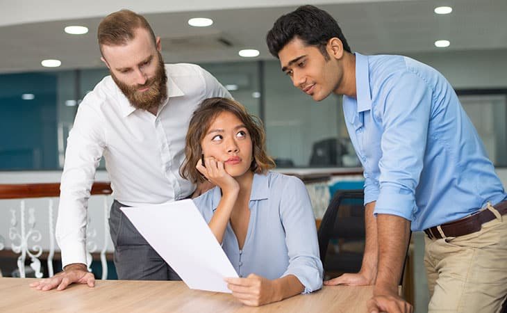 three workers worried in an office