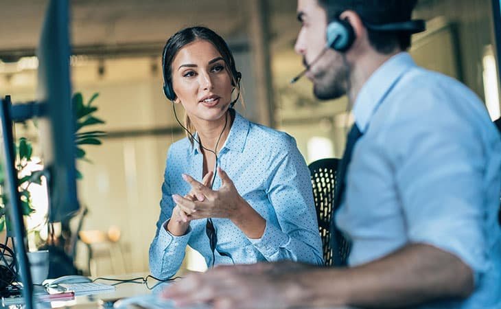 two workers talking wearing a headset