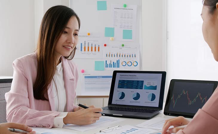 woman talking to another woman in the office