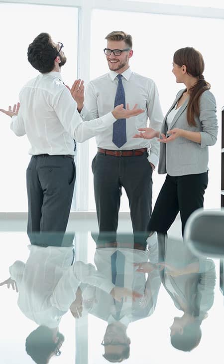 three people in an office making gestures while talking