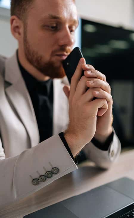 man-thinking-looking-laptop-phone