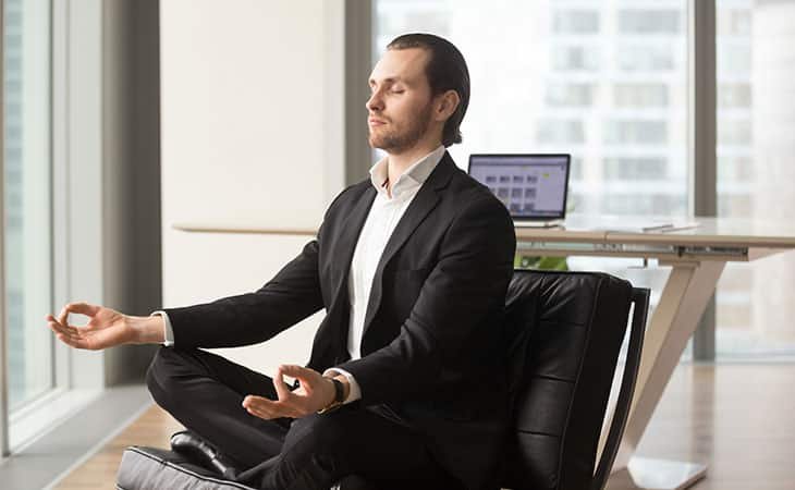 man-meditating-office