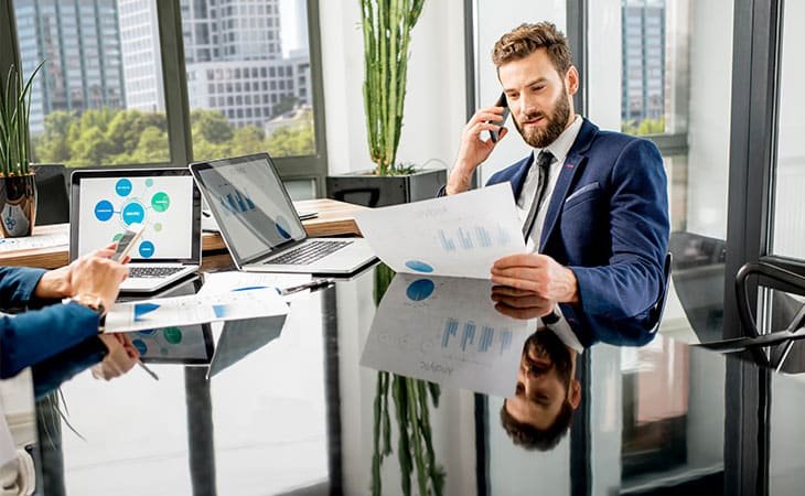 man-phone-papers-hand-table