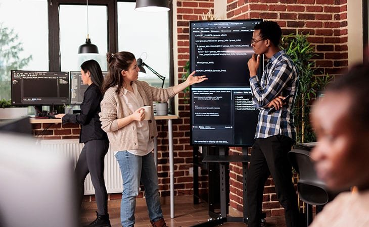 coders-discussing-code-screen-office