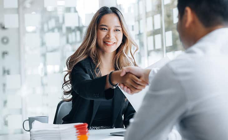 happy-woman-handshake-interviewer