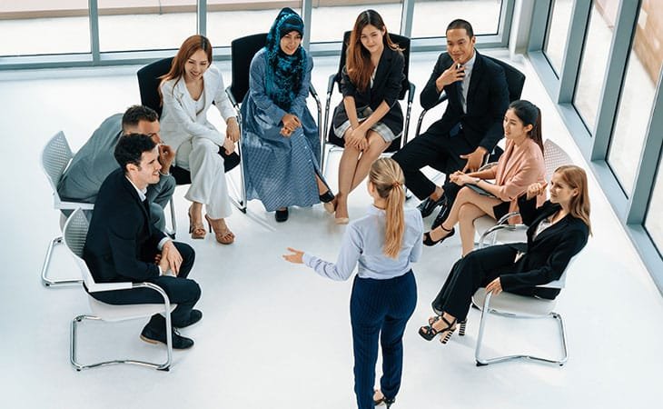woman giving a speech to diverse people