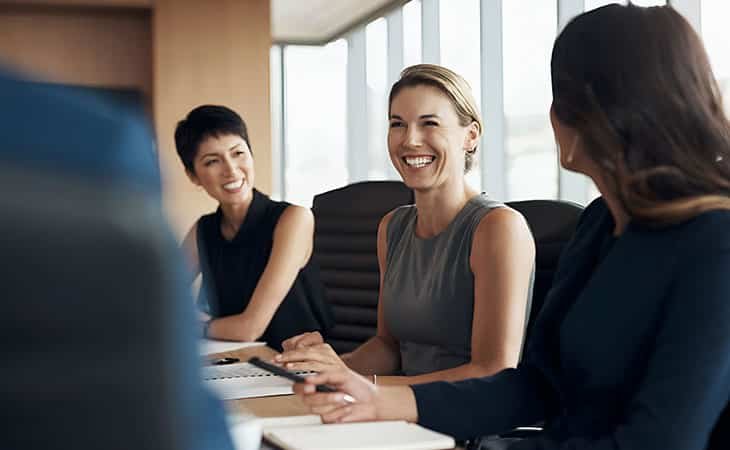 women smiling in a meeting at the office
