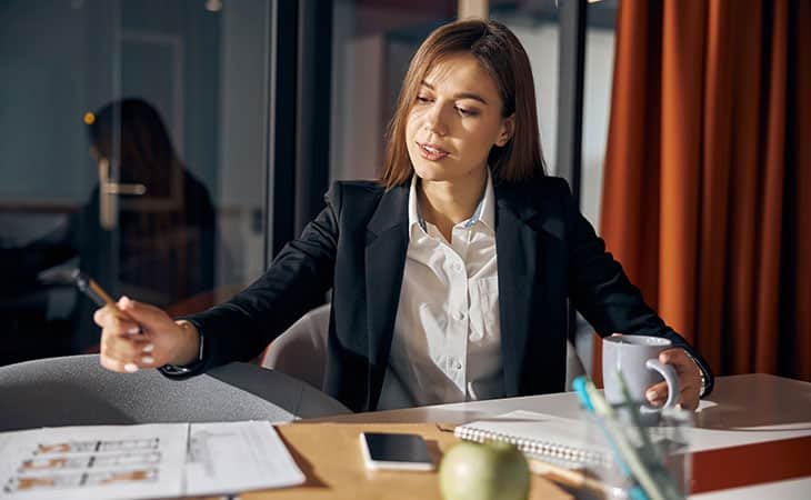 diligent-woman-working-office-pen-papers