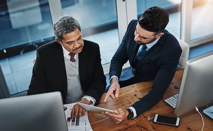 two-men-talking-office-tablet