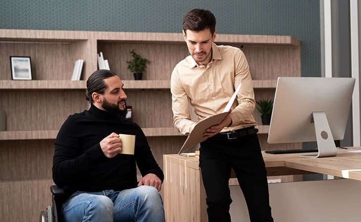 two-men-talking-papers