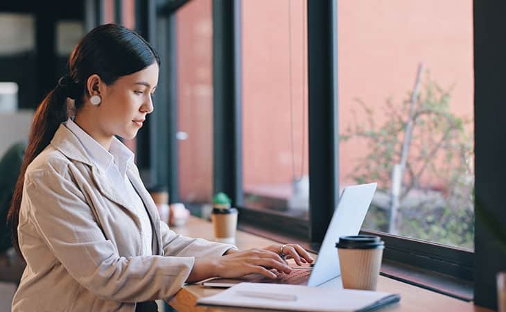 woman-working-laptop-window