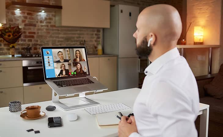 a man making a video call using his laptop