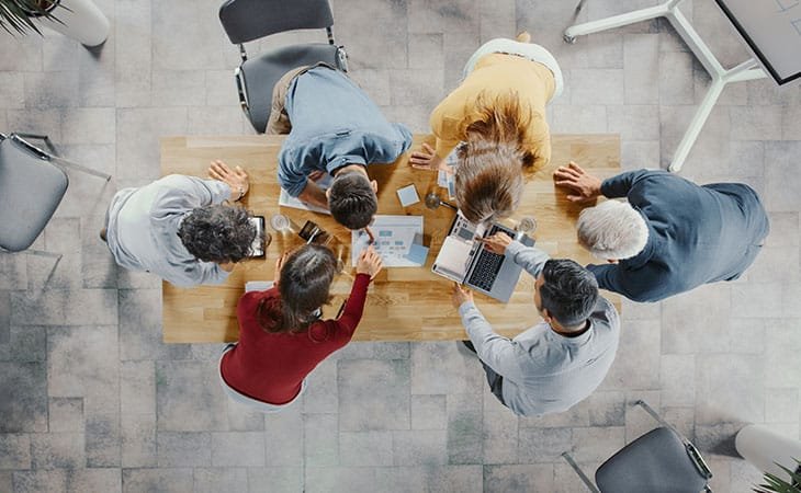 cenital shot of people working around a table