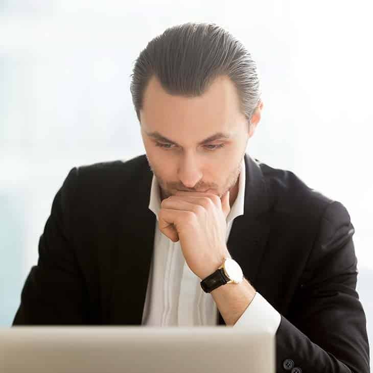 focused businessman looking at computer