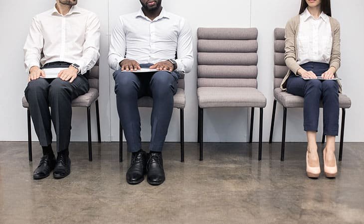 three people sitting in chairs